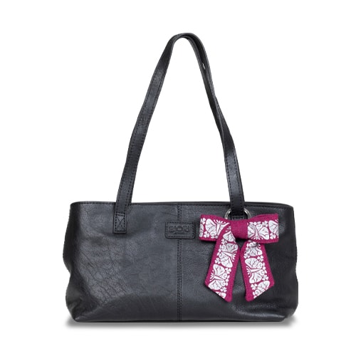 Väska prydd med ett smycke i form av en reflexrosett. I färgen anemonrosa med reflexmönster av nattfjäril.