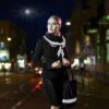 Girl wearing a stylish reflective shawl from Smart in the dark - smart reflective scarf to stay visible in traffic!
