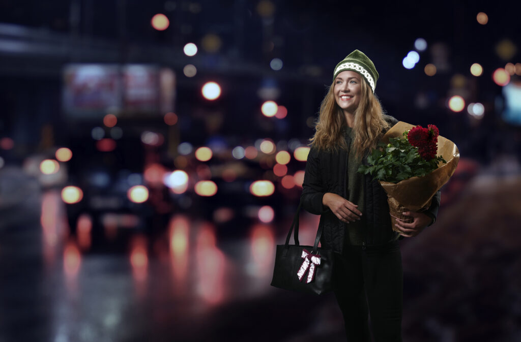 Girl in traffic wearing high quality reflectors in the form of a reflective wool beanie by Smart in the dark
