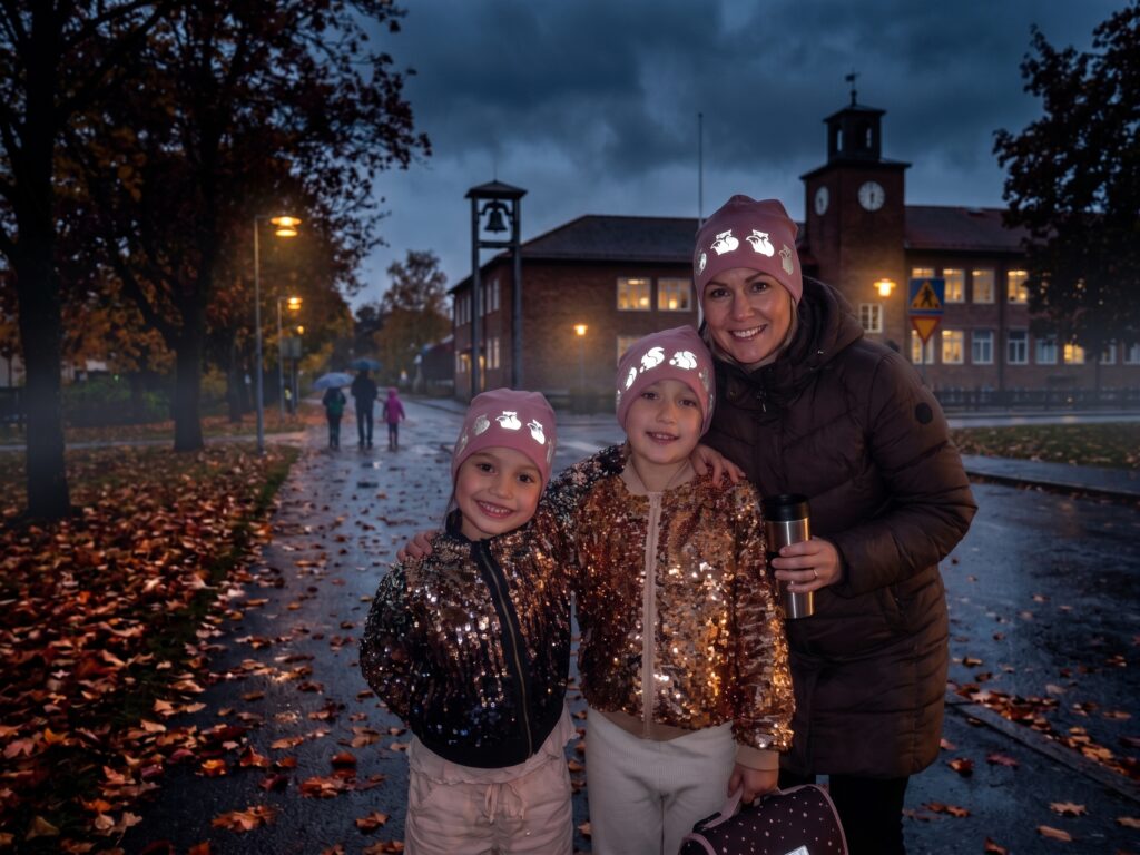 Woman and two girls school traffic safety wearing Pink Peony reflective beanie for kids from Smart in the dark